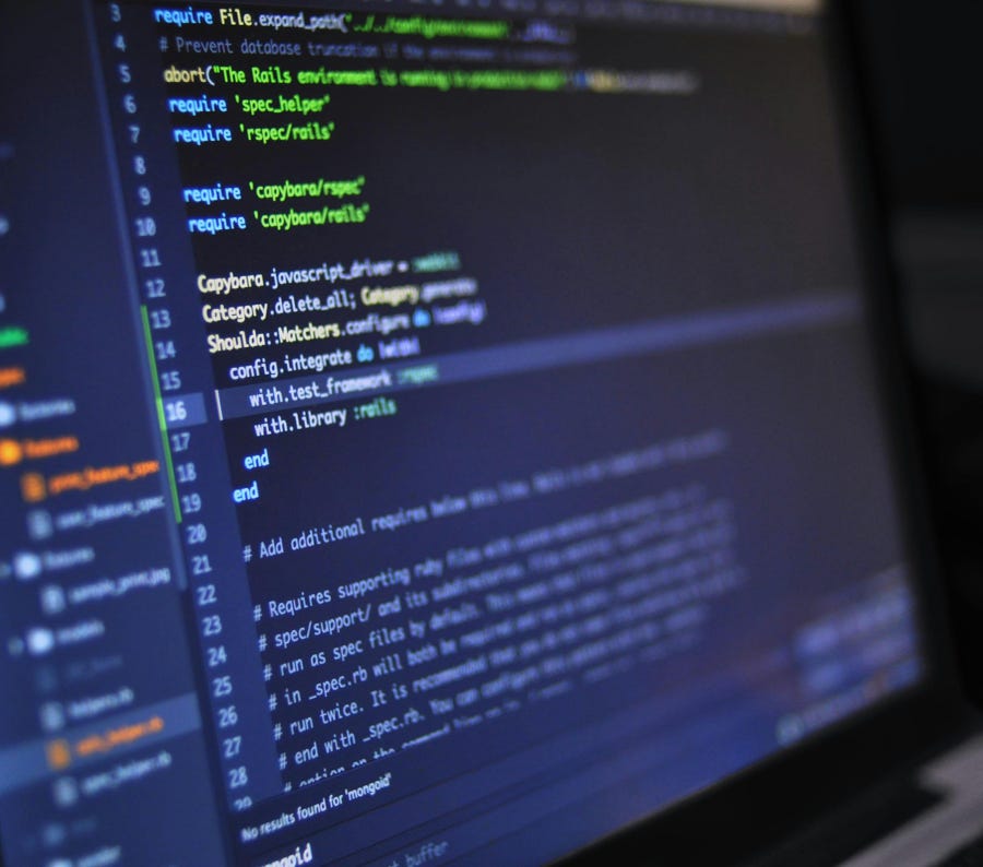 A close-up of a person analyzing blue graph data with a yellow pencil.